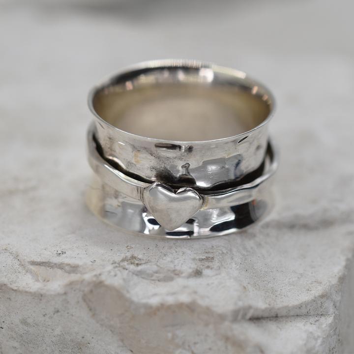 Wide Silver spinning ring with single heart.